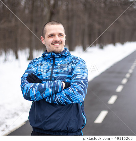 Sporty man runner looking on side and smiling 49115263