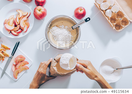 View from above woman adding flour View from above woman adding flour 49115634