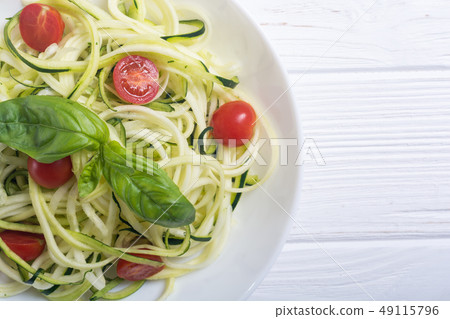 Zucchini pasta noodles with tomatoes . Healthy 49115796