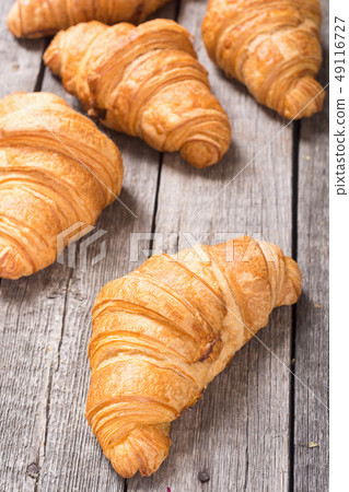 Croissants on wooden background 49116727