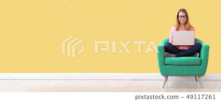 Young woman using a laptop Young woman using a laptop 49117261