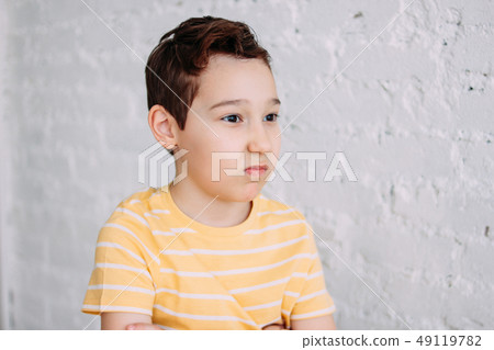 Cute tween angry boy with funny face in yellow 49119782