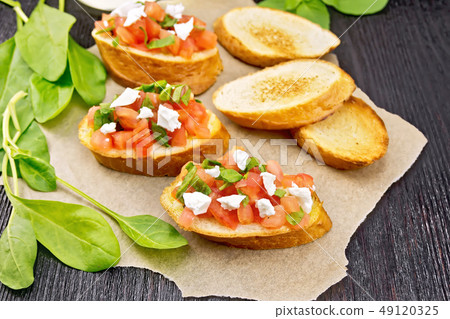 Bruschetta with tomato and cheese on board 49120325