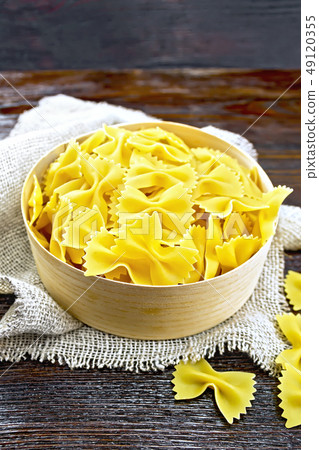 Farfalle in box on dark board Farfalle in box on dark board 49120355