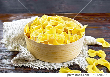 Farfalle in bark box on wooden board Farfalle in bark box on wooden board 49120663