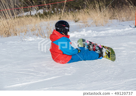 A child sitting on a slope A child sitting on a slope 49120737