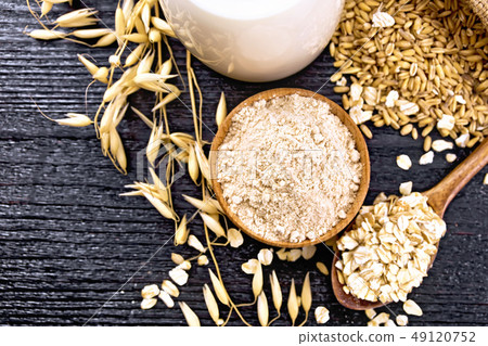 Flour oat in bowl on wooden board top Flour oat in bowl on wooden board top 49120752