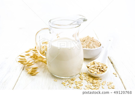 Milk oatmeal in jug on light table Milk oatmeal in jug on light table 49120768