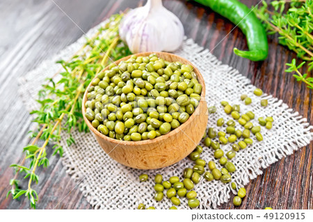 Mung beans in wooden bowl with thyme and pepper on Mung beans in wooden bowl with thyme and pepper on 49120915
