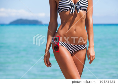 Woman body in bikini and sunglasses 49123183