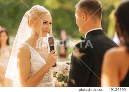 Wedding couple on ceremony outside. beautiful bride and handsome groom. Just married 49124893