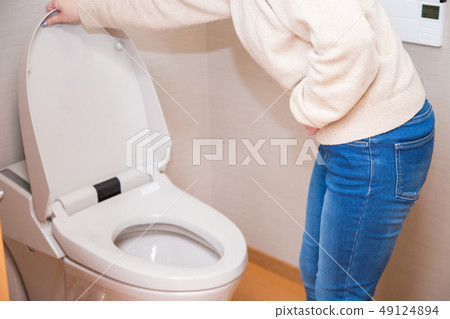 Woman holding a stomach in the bathroom 49124894