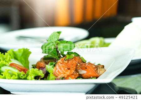 Spicy Salmon Salad with fresh mint and basil 49125421