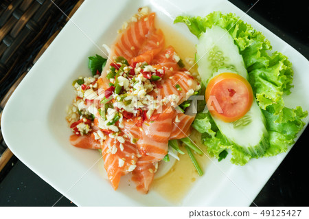 Spicy Salmon Salad with fresh chilli and garlic 49125427