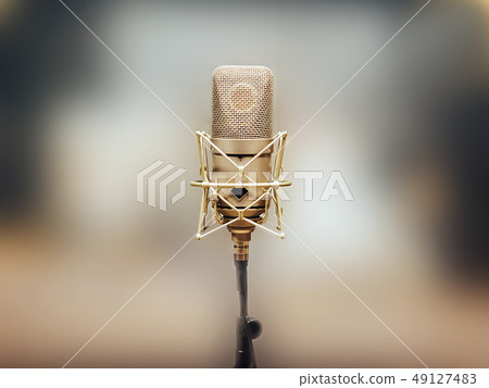 microphone on a stand, a blurry colored background microphone on a stand, a blurry colored background 49127483