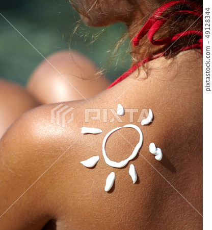 Woman With Suntan Lotion At The Beach In Form Of 49128344
