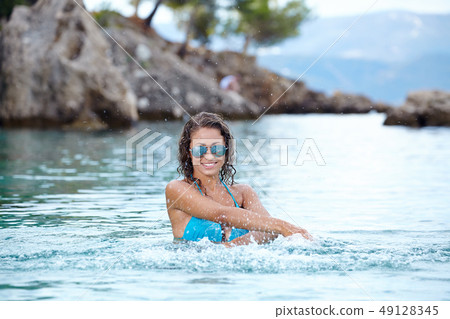 Sexy  bikini model splashing water 49128345