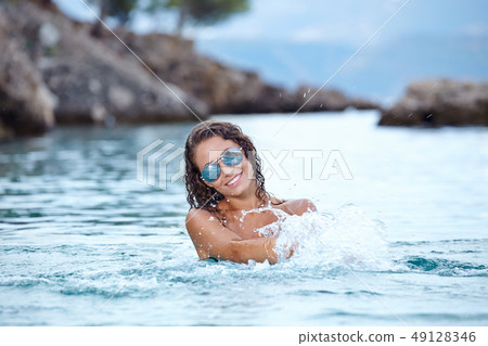 Sexy  bikini model splashing water 49128346