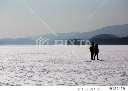 Snow-covered, frozen river 49129459