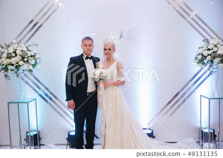 Beautiful groom and bride in restaurant. Newlyweds Beautiful groom and bride in restaurant. Newlyweds 49131135