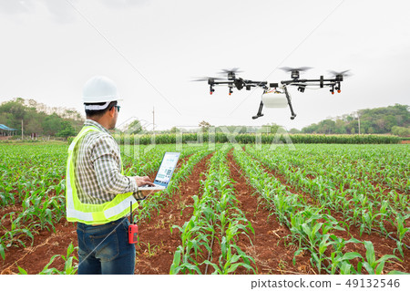 Technician farmer use wifi computer control drone 49132546