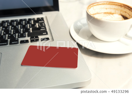 mockup red credit card on laptop computer mockup red credit card on laptop computer 49133296