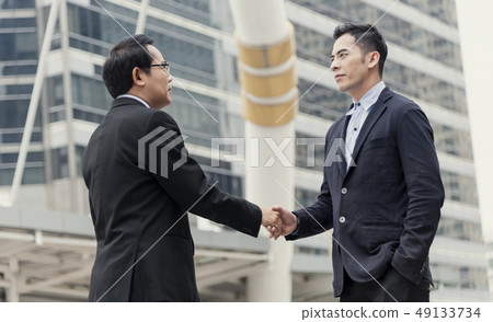 Businessman making handshake agreement.  49133734