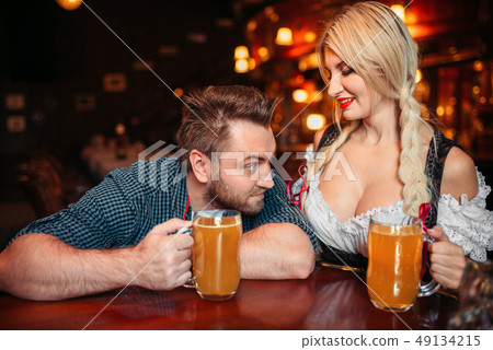 Surprised drunk man stairs at breasts of waitress 49134215