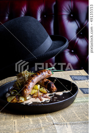 Traditional German Sausages with Potato served in pan. Restaurant dish. Side View Traditional German Sausages with Potato served in pan. Restaurant dish. Side View 49135553
