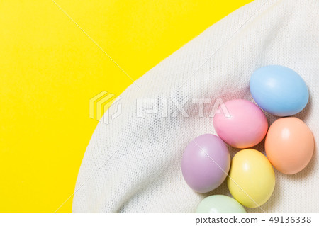 colorful easter eggs on yellow  background 49136338
