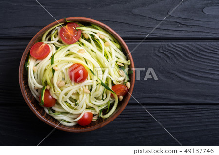 Zucchini pasta noodles with tomatoes . Healthy 49137746
