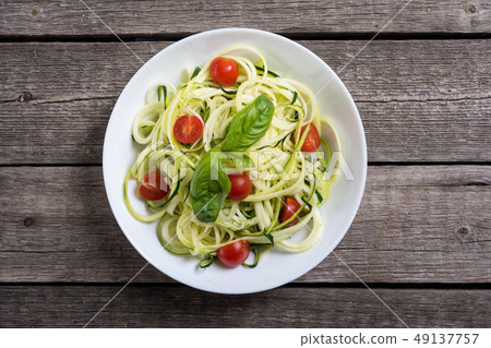 Zucchini pasta noodles with tomatoes . Healthy 49137757