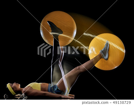 woman exercising fitness exercises isolated black background lightpainting effect 49138729