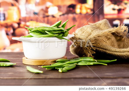 Green sugar snap pea with rustic kitchen Green sugar snap pea with rustic kitchen 49139266