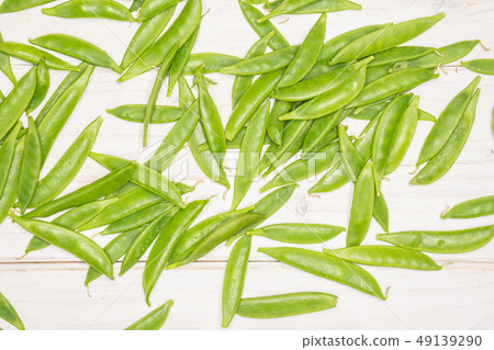 Green sugar snap pea on grey wood Green sugar snap pea on grey wood 49139290