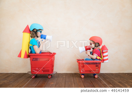 Happy children driving toy car at home Happy children driving toy car at home 49141459