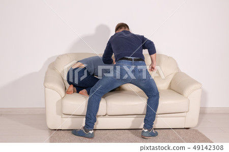 people, abuse and violence concept - angry aggressive husband trying to hit his wife 49142308