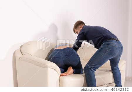 people, abuse and violence concept - angry aggressive husband trying to hit his wife people, abuse and violence concept - angry aggressive husband trying to hit his wife 49142312
