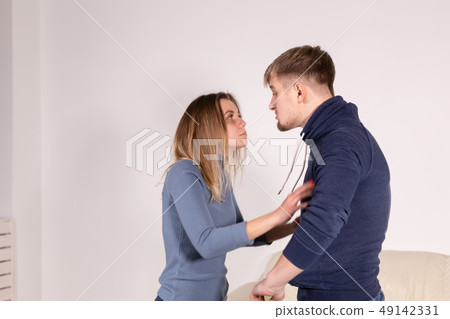People, abuse and domestic violence concept - Portrait of man beating woman at home People, abuse and domestic violence concept - Portrait of man beating woman at home 49142331