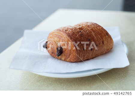closeup of french chocolatine on table closeup of french chocolatine on table 49142765