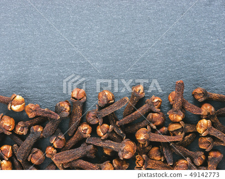 Cloves on slate background Cloves on slate background 49142773