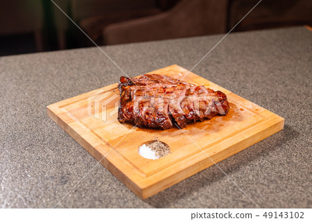 food, delicious and craft concept - cutting horse meat steak on wooden desk food, delicious and craft concept - cutting horse meat steak on wooden desk 49143102