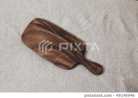 An old homemade cutting board of walnut color 49146946
