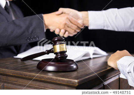 judge and client shaking hands in background at 49148731