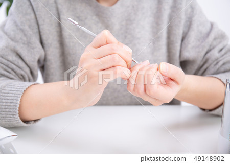 Woman doing jewel nails 49148902