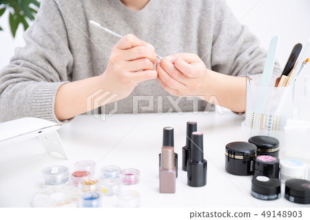 Woman doing jewel nails Woman doing jewel nails 49148903