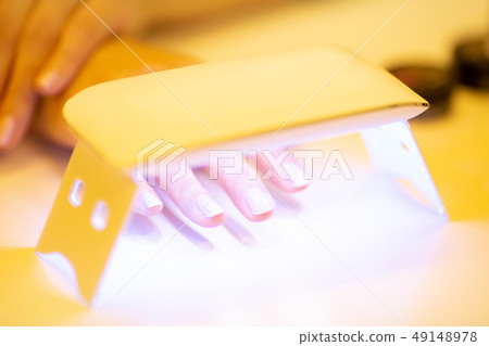 Woman doing jewel nails Woman doing jewel nails 49148978