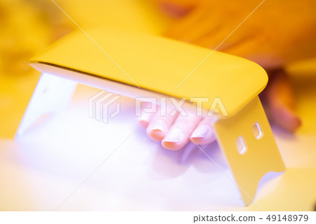 Woman doing jewel nails Woman doing jewel nails 49148979