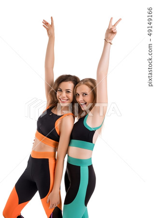 Two slim girls in sportswear doing fitness view 49149166