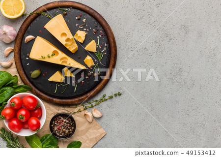 Cheese, tomatoes and fresh herbs on concrete background. Cheese, tomatoes and fresh herbs on concrete background. 49153412
